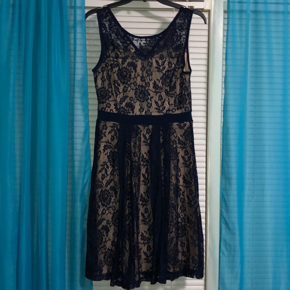 A navy blue lacy dress with nude under